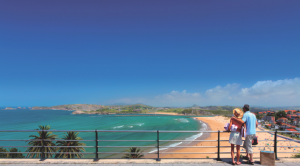 An image of a couple looking at a beach in suances